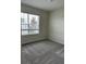 Cozy bedroom with neutral carpet, one window overlooking the neighborhood, and ample natural light at 7408 Olivewood Ave, Orlando, FL 32829