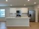 Modern kitchen featuring stainless steel appliances and a large center island at 7408 Olivewood Ave, Orlando, FL 32829