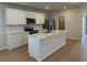 Modern kitchen featuring stainless steel appliances, white cabinets, and a spacious center island at 7408 Olivewood Ave, Orlando, FL 32829