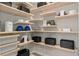 Organized walk-in pantry with ample shelving, providing plenty of storage space at 7408 Olivewood Ave, Orlando, FL 32829