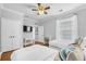 Bedroom with hardwood floors, a ceiling fan, two twin beds and access to a view of another room at 8020 Tuscany Way # 6301, Davenport, FL 33896