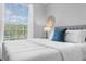 Bedroom with large window offering natural light, ceiling fan, and comfy bedding at 8020 Tuscany Way # 6301, Davenport, FL 33896