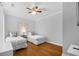 Cozy bedroom with hardwood floors and two twin beds adorned with patterned pillows at 8020 Tuscany Way # 6301, Davenport, FL 33896
