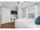 Bright bedroom with hardwood floors, white trim, and natural light from the large window at 8020 Tuscany Way # 6301, Davenport, FL 33896