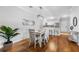 Open dining area with hardwood floors, seating for four, and a view into the kitchen at 8020 Tuscany Way # 6301, Davenport, FL 33896