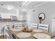 Dining area open to kitchen featuring a decorative light fixture and a breakfast bar at 8020 Tuscany Way # 6301, Davenport, FL 33896