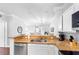 Bright kitchen with a breakfast bar, stainless steel dishwasher, and an open view to the dining area at 8020 Tuscany Way # 6301, Davenport, FL 33896