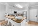Updated kitchen with granite countertops, stainless steel appliances, and a breakfast bar with seating at 8020 Tuscany Way # 6301, Davenport, FL 33896