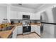 An updated kitchen featuring stainless steel appliances, countertops, and ample cabinet space for storage at 8020 Tuscany Way # 6301, Davenport, FL 33896