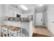A view of the kitchen with modern appliances, white cabinets, a breakfast bar with seating, and tile flooring at 8020 Tuscany Way # 6301, Davenport, FL 33896