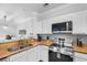 Well-lit kitchen featuring stainless steel appliances, a breakfast bar, and white cabinetry at 8020 Tuscany Way # 6301, Davenport, FL 33896
