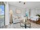 Comfortable living room with access to balcony, ceiling fan, and stylish decor throughout at 8020 Tuscany Way # 6301, Davenport, FL 33896