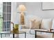 Comfortable living room featuring stylish decor, natural light, and access to an outdoor balcony at 8020 Tuscany Way # 6301, Davenport, FL 33896