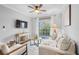 Bright living room featuring a ceiling fan, comfortable seating, and sliding glass doors to a balcony at 8020 Tuscany Way # 6301, Davenport, FL 33896