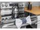 Close-up of a stainless steel oven showcasing modern features and stylish design with tea kettle on stovetop at 8020 Tuscany Way # 6301, Davenport, FL 33896