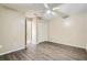 Bright bedroom with hardwood floors, ceiling fan, and closet space, creating a comfortable and inviting space at 830 N Sunset Dr, Mount Dora, FL 32757