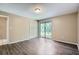 Spacious bedroom with hardwood floors, closet, and access to outdoor space for a relaxing environment at 830 N Sunset Dr, Mount Dora, FL 32757