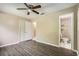 Cozy bedroom with hardwood floors, ensuite bathroom, and closet space, creating a private retreat at 830 N Sunset Dr, Mount Dora, FL 32757