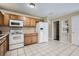 Well-lit kitchen featuring ample cabinetry, modern appliances, and tile flooring, perfect for everyday cooking at 830 N Sunset Dr, Mount Dora, FL 32757