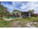 Backyard pool with safety fence and screened lanai adjacent to the house at 830 N Sunset Dr, Mount Dora, FL 32757
