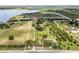 Picturesque acreage with a stately residence, open fields, and lake frontage, offering a blend of elegance and natural beauty at 9400 Laws Road, Clermont, FL 34714