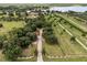 Beautiful aerial view of the property showing the long private drive and mature trees at 9400 Laws Road, Clermont, FL 34714