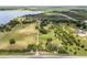 Sprawling property with a long driveway, manicured lawns, and peaceful lake nearby at 9400 Laws Road, Clermont, FL 34714