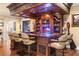 A well-appointed home bar with dark wood cabinetry, a neon sign, and comfortable seating at 9400 Laws Road, Clermont, FL 34714