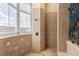 Bright bathroom features a tiled shower with window and built-in niche at 9400 Laws Road, Clermont, FL 34714
