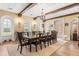Formal dining room with wood beams, a chandelier, and large windows, creating an elegant setting for meals at 9400 Laws Road, Clermont, FL 34714