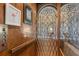 Unique elevator with ornate metal gate and wood paneling, adding character to the home at 9400 Laws Road, Clermont, FL 34714