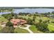 Expansive lakefront estate with lush landscaping, circular drive, and stately architecture at 9400 Laws Road, Clermont, FL 34714
