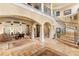 Grand foyer with soaring ceilings, marble floors, and an elegant staircase at 9400 Laws Road, Clermont, FL 34714