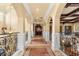 Elegant hallway featuring arched doorways, decorative columns, and ornate iron railings at 9400 Laws Road, Clermont, FL 34714