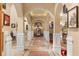 Elegant hallway with arched doorways and tile flooring at 9400 Laws Road, Clermont, FL 34714