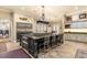 Open-concept kitchen boasts a large island, custom cabinetry, and stainless steel appliances at 9400 Laws Road, Clermont, FL 34714