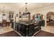 Kitchen island with sink, stainless steel appliances, and barstool seating at 9400 Laws Road, Clermont, FL 34714