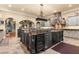 A kitchen island with granite countertops, stainless steel appliances, and elegant fixtures at 9400 Laws Road, Clermont, FL 34714