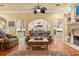 A warm living room featuring a fireplace and arched doorways at 9400 Laws Road, Clermont, FL 34714