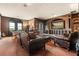 Cozy living room with leather seating, built-in entertainment center, and natural light at 9400 Laws Road, Clermont, FL 34714