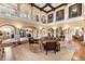 Spacious living room featuring soaring ceilings, elegant arches, and comfortable seating at 9400 Laws Road, Clermont, FL 34714