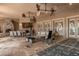 Outdoor patio with stone fireplace, dining area, and comfortable seating at 9400 Laws Road, Clermont, FL 34714