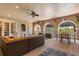 Inviting covered patio with ample seating and a ceiling fan for relaxed outdoor living at 9400 Laws Road, Clermont, FL 34714