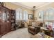 Comfortable sitting area with a plush armchair, bookcase, and an abundance of natural light at 9400 Laws Road, Clermont, FL 34714