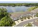Aerial view of townhomes with lake view, balconies, and lush landscaping at 995 Grand Wildmere, Longwood, FL 32750
