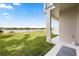 Back porch overlooking a green yard with a gorgeous lake view at 995 Grand Wildmere, Longwood, FL 32750