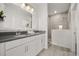 Bright bathroom featuring a double vanity with a large mirror and walk-in shower at 995 Grand Wildmere, Longwood, FL 32750