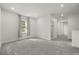 Light-filled bedroom with neutral carpet, large window, and access to an ensuite bathroom at 995 Grand Wildmere, Longwood, FL 32750