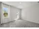 Well-lit bedroom featuring gray carpeting and access to an exterior door at 995 Grand Wildmere, Longwood, FL 32750