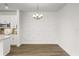 Dining area with elegant chandelier, decorative wall, and hardwood floors at 995 Grand Wildmere, Longwood, FL 32750